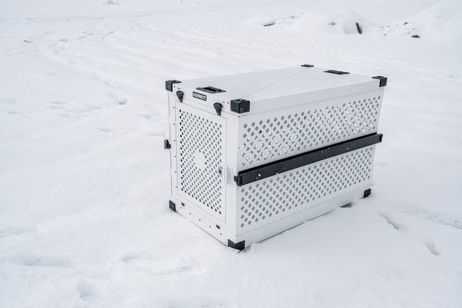 Sturdy pet crate designed for cold conditions, shown in a snowy outdoor setting.