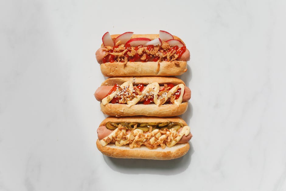 Delicious gourmet hot dogs with various savory toppings on a white background.